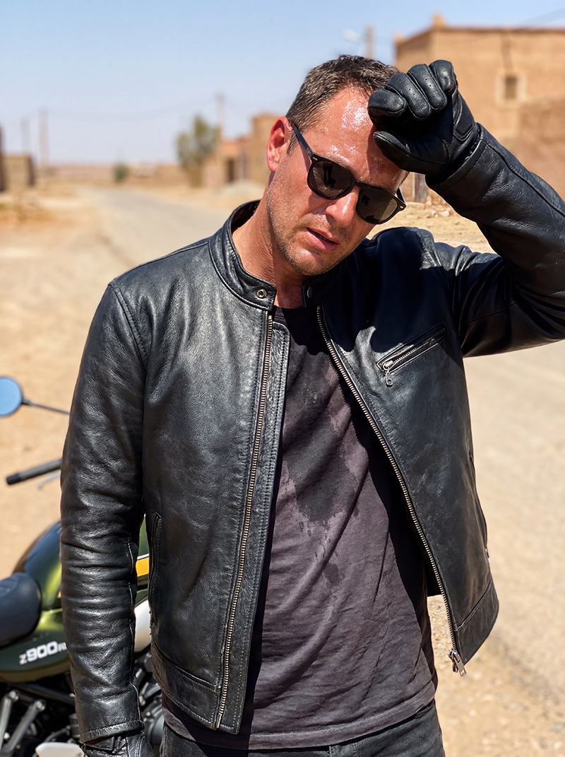 Guy wearing leather motorcycle jacket in hot conditions